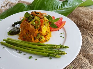 Vegetarian dish of chopped vegetables with sauce, similar to fried rice. The concept of healthy food, vegetarian diet, festive snacks, a dish for a restaurant. Lay flat.