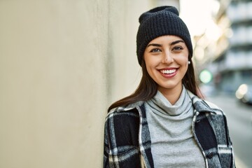 Young hispanic woman smiling happy standing at the city.