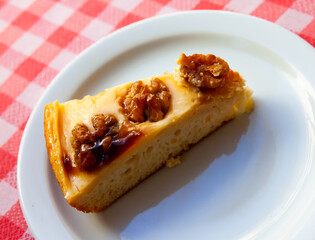 Slice of delicious nut pie on white plate, homemade pastry