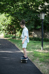 Fototapeta premium boy learn how to ride the skate on the pedestrian road