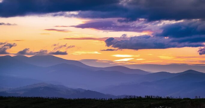 Sunset over Hoverla (goverla), Chornohora ridge, time laps of rapidly flying red clouds over the highest peak of Ukraine, 2061 meters. Time lapse accelerated video, cloud and light dynamics.