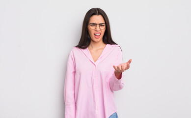 pretty young woman looking angry, annoyed and frustrated screaming wtf or what’s wrong with you