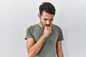 Young hispanic man with beard wearing casual t shirt over white background feeling unwell and...