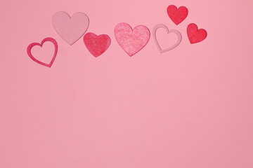 Fototapeta na wymiar Red hearts on pink background, love card