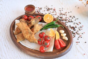 Fried fillet of carp with vegetables