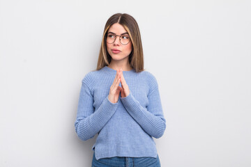 pretty young woman feeling proud, mischievous and arrogant while scheming an evil plan or thinking...