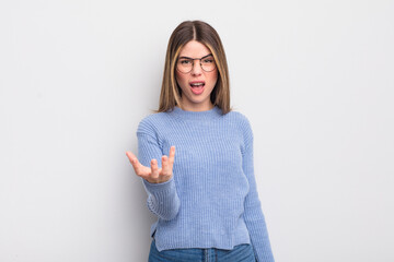 pretty young woman looking angry, annoyed and frustrated screaming wtf or what’s wrong with you