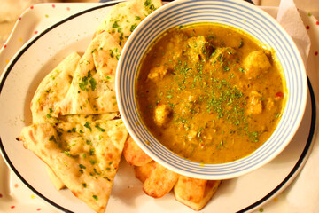Chicken curry spicy in Indian food style, side dish with garlic bread and chips, easy cook at home.