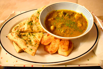 Chicken curry spicy in Indian food style, side dish with garlic bread and chips, easy cook at home.