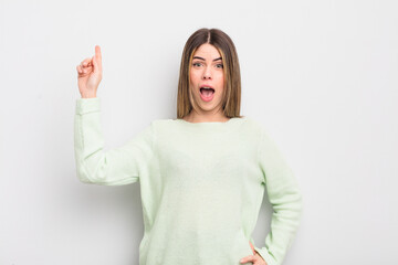 pretty young woman feeling like a happy and excited genius after realizing an idea, cheerfully...