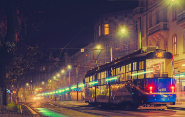 Obraz premium Shining tram on the night street of the old city