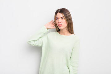 pretty young woman looking serious and curious, listening, trying to hear a secret conversation or...