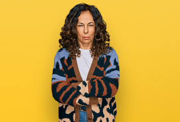 Middle age hispanic woman wearing casual clothes skeptic and nervous, disapproving expression on...