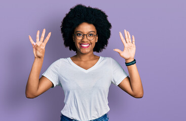Young african american woman wearing casual white t shirt showing and pointing up with fingers...