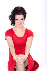 Beautiful brunette woman in a red dress..