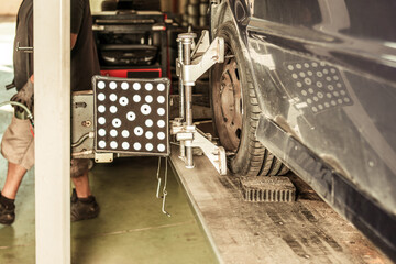 Mechanic lifting a car with a pneumatic jack