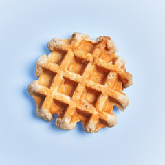  Single delicious waffle over blue background