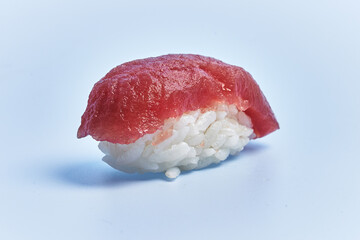  Single tuna nigiri sushi over blue background