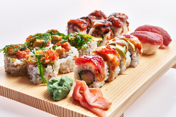  Wooden board of sushi isolated over white background