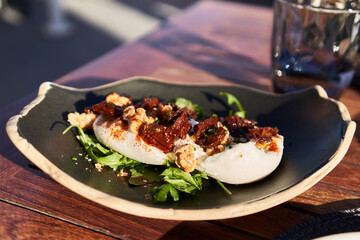  Plate of burrata salad on wooden surface