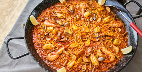  Delicious spanish shellfish paella on cloth surface