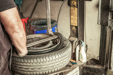 Man removing leads from wheel using electric tools in a workshop