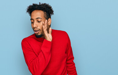 Fototapeta na wymiar Young african american man with beard wearing casual winter sweater hand on mouth telling secret rumor, whispering malicious talk conversation