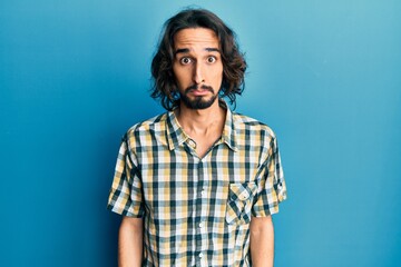 Young hispanic man wearing casual clothes depressed and worry for distress, crying angry and afraid. sad expression.