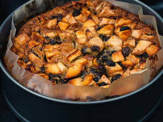 Freshly baked apple pear rum cake in the spring form with parchment paper.