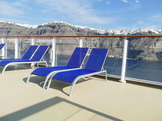 Deck chairs on cruise ship anchored off Santorini
