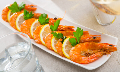 Delicious grilled shrimps served with parsley and lemon..