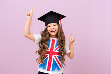 a joyful schoolgirl on an isolated background. a student with an English flag on her T-shirt. the...