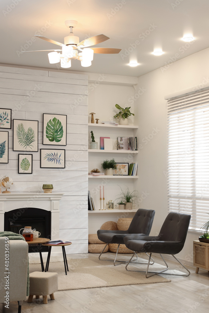 Wall mural stylish living room interior with comfortable chairs and decorative fireplace