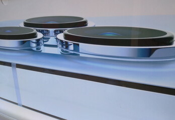 Close-up shot of a smartphone camera placed on a clear glass floor, modern communication technology in the digital era.