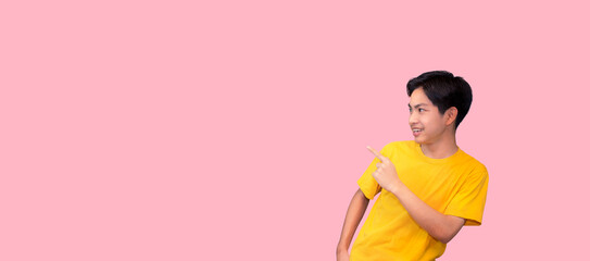 Handsome healthy young Asian man smiling with his finger pointing isolated