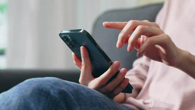 Hand holding smartphone and chatting online on mobile, During leisure time.
