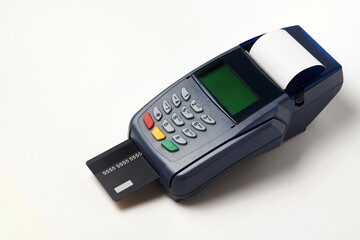 Payment terminal and credit card on white background
