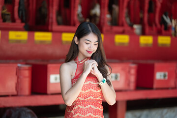 Beautiful Asian woman with congratulate gesture in Chinese New Year