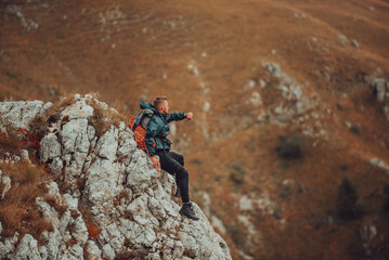 A male traveler hiking on the mountain peak rock adventure travel extreme sport outdoor.
