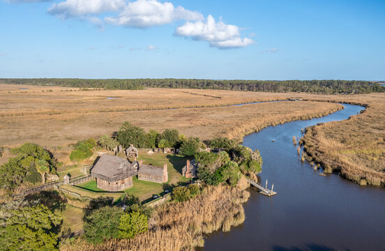Aerial view of Fort King George historic site, oldest English fort on the Georgia coast from the 17th century with wooden palisade, gun ports for cannons blue cloudy sky near Darien Georgia USA