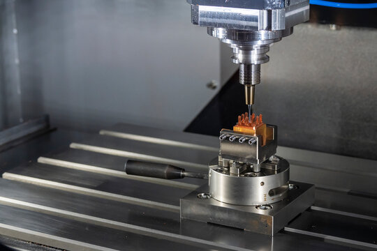 The CNC milling machine cutting the  copper electrode parts with solid ball end mill tools.