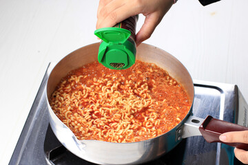 Bandung, Indonesian, 122202018: Cooking Korean Spicy Ramyun, Add Herbs to the Pan