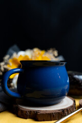 Blue mug on wooden coaster
