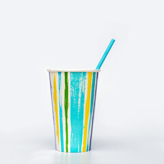 Colorful paper cup or container for coffee or cocktail and paper drinking straw on light Bright summer package for beverage.