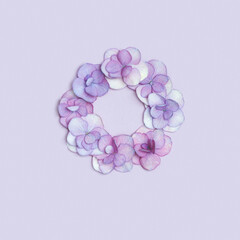 Minimal floral frame with fresh Hydrangea flower, Very Peri colored flat lay. Monochrome image with fresh flowers. Holiday card or invitations for Mothers day, 8 March, Womens day.