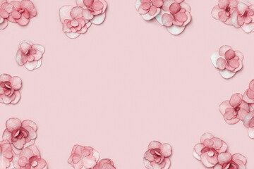 Minimal floral frame with small fresh Hydrangea pink flower on pink background. Holiday flowery arrangement with blooms for Mothers day,Valentines day, Womens day. Top view, flat lay