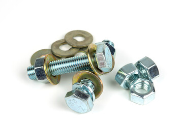 several metal bolts with washers and nuts on a white background. close-up
