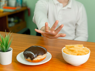 Child refuses to eat unhealthy fast food. Healthy eating and active lifestyle concept. Boy doesn't want to eat. Healthy food. Kids diet. Poor appetite. Stop gesture. Do not force the child to eat.