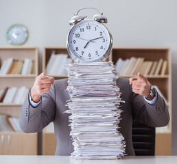 Businessman busy with paperwork in office