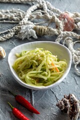 Sichuan radish. Green radish salad with carrots and cayenne pepper.